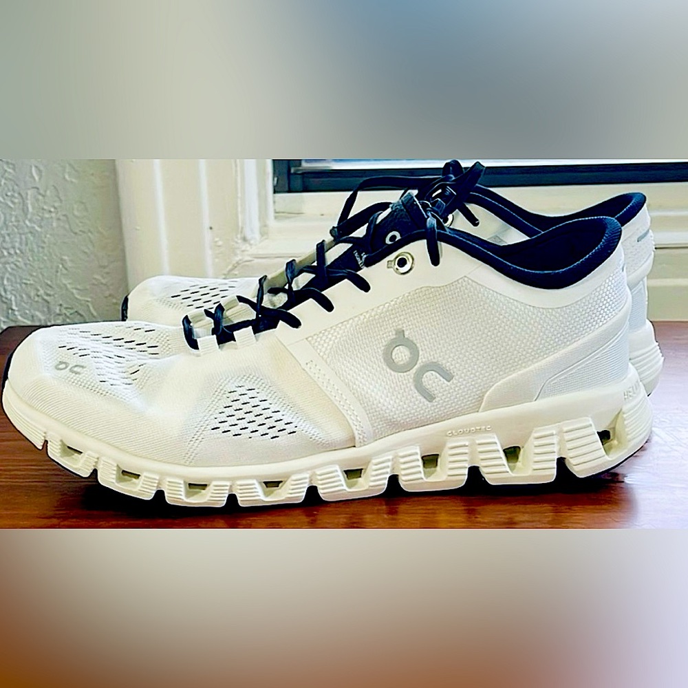 On Running White and Black Athletic Shoes with Cloud Cushioning
